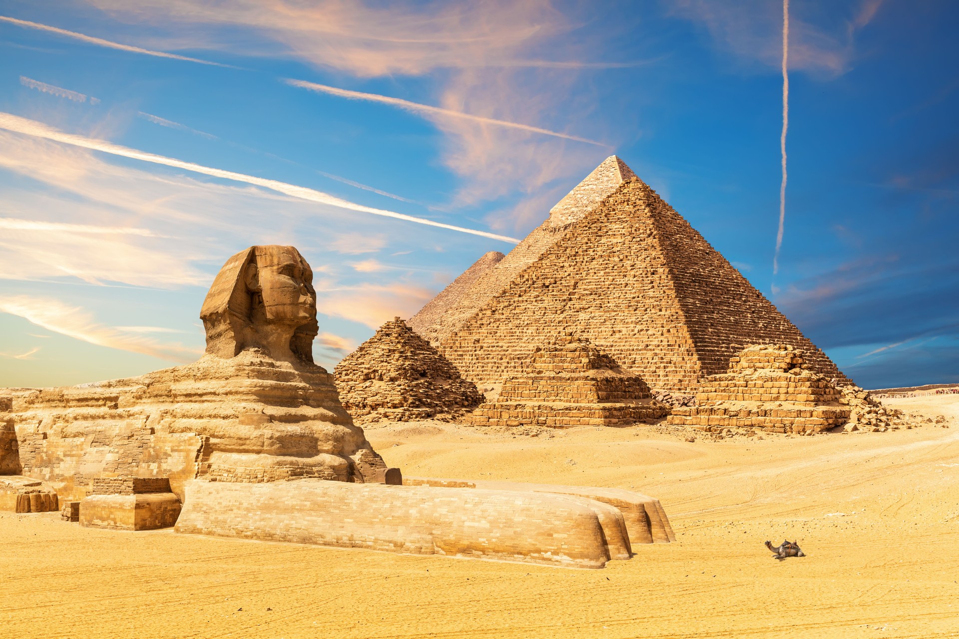 The Sphinx next to the Pyramids in the sands of Giza desert, Egypt